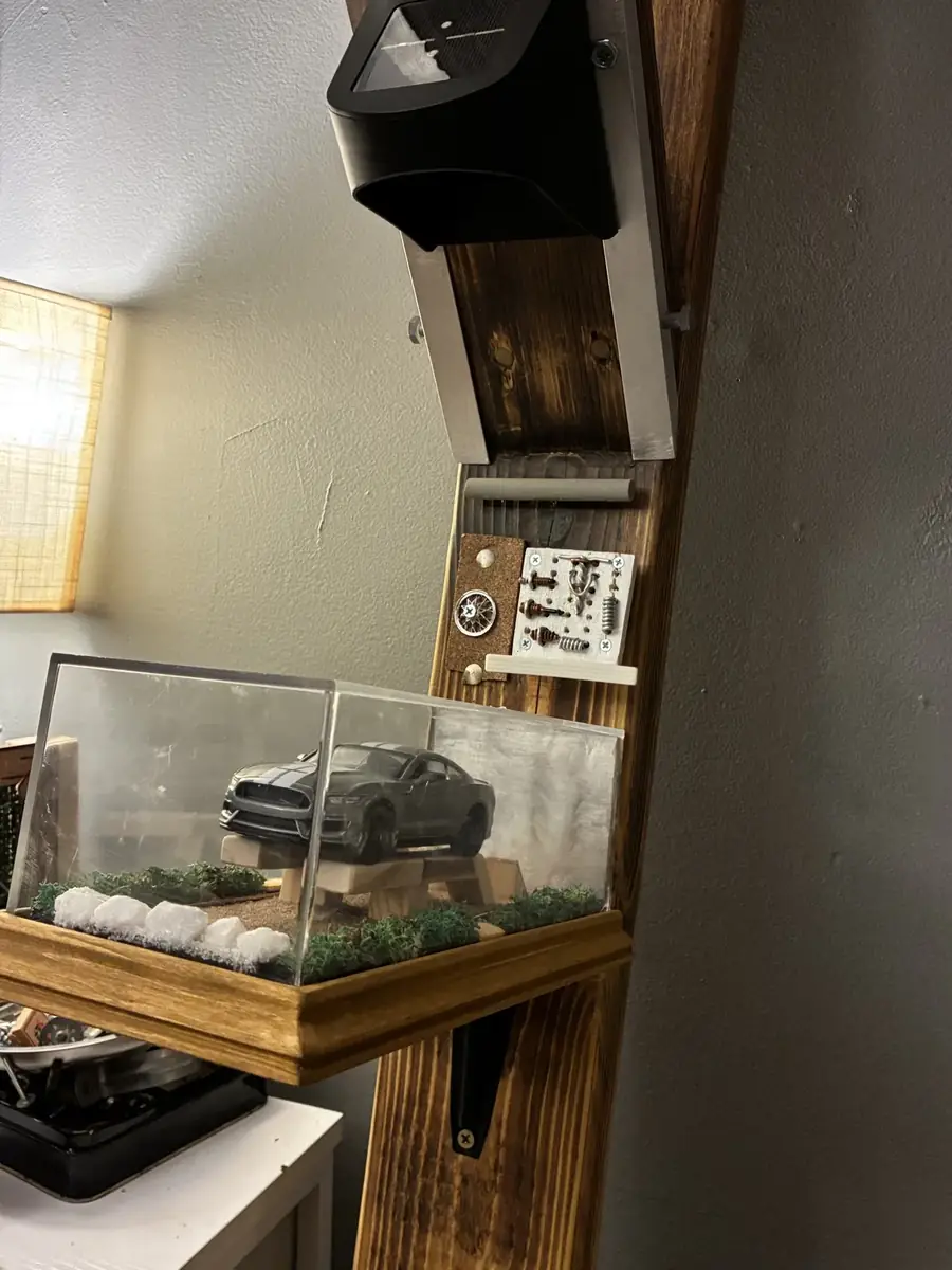 Custom garage-themed post with diecast Mustang display